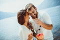 Couple eating fruit on the beach- summer party with friends and healthy food concept Royalty Free Stock Photo