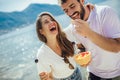 Couple eating fruit on the beach- summer party with friends and healthy food concept Royalty Free Stock Photo