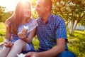 Young couple eating ice-cream and chatting outside. Woman and man chilling out in spring garden at sunset. Lifestyle Royalty Free Stock Photo