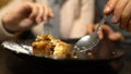 Young couple eating sweet pie, thrifty poor students on romantic date close up