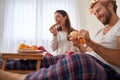 A young couple eating a tasty food for a breakfast in the bed. Love, relationship, together Royalty Free Stock Photo