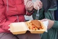 Young couple is eating traditional London food fish and chips fr