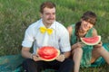 Young couple eating watermelon