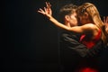 Young couple in elegant evening dresses dancing