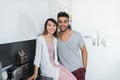 Young Couple Embrace In Kitchen, Hispanic Man And Asian Woman Hug Royalty Free Stock Photo