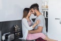 Young Couple Embrace In Kitchen, Hispanic Man And Asian Woman Hug Royalty Free Stock Photo