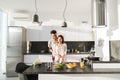 Young Couple Embrace In Kitchen, Hispanic Man And Asian Woman Hug Royalty Free Stock Photo