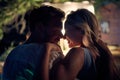 Young couple in embrace at outdoor movie night. Close up portrait shot of young man and woman in close hug feeling happy. Holiday Royalty Free Stock Photo
