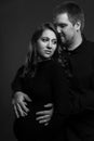 Young couple embrace tenderly and sensually. Black and white photo. Vertical. Pregnant woman with her husband Royalty Free Stock Photo