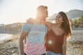 Young couple embracing each other on beach laughing Royalty Free Stock Photo