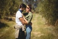 Young couple embracing at olive farm on sunny day Royalty Free Stock Photo