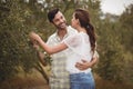 Young couple embracing by olive trees at farm Royalty Free Stock Photo