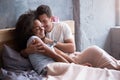 Young couple embracing in their bed tenderly Royalty Free Stock Photo