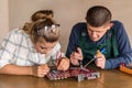 Young couple of engineers repairing computer device Royalty Free Stock Photo