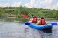 Young couple enjoy white water kayaking on the river Royalty Free Stock Photo