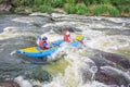 Young couple enjoy white water kayaking on the river Royalty Free Stock Photo