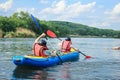 Young couple enjoy white water kayaking on the river Royalty Free Stock Photo