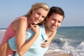 Young Couple Enjoying Beach Holiday In The Sun