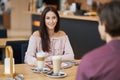 Young Couple Enjoying Coffee And Cake In Cafe Royalty Free Stock Photo