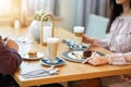 Young Couple Enjoying Coffee And Cake In Cafe Royalty Free Stock Photo