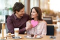 Young Couple Enjoying Coffee And Cake In Cafe Royalty Free Stock Photo