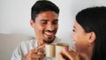 Young couple enjoying coffee on comfy couch closeup. Family talking laughing