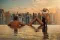 Couple enjoying Dubai skyline with skyscrapers architecture from hotel infinity pool at sunset. luxury vacation and travel. United