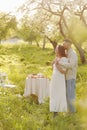 Young couple enjoying food and drinks in beautiful summer green park on romantic date picnic, handsome man and woman Royalty Free Stock Photo