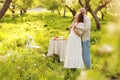 Young couple enjoying food and drinks in beautiful summer green park on romantic date picnic, handsome man and woman Royalty Free Stock Photo