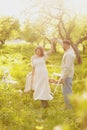 Young couple enjoying food and drinks in beautiful summer green park on romantic date picnic, handsome man and woman Royalty Free Stock Photo