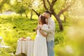 Young couple enjoying food and drinks in beautiful summer green park on romantic date picnic, handsome man and woman Royalty Free Stock Photo