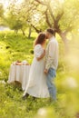 Young couple enjoying food and drinks in beautiful summer green park on romantic date picnic, handsome man and woman Royalty Free Stock Photo