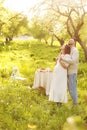 Young couple enjoying food and drinks in beautiful summer green park on romantic date picnic, handsome man and woman Royalty Free Stock Photo