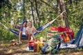 Young couple enjoying on the hammock at the camp in the forest. Camping, people, nature