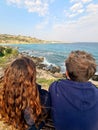 Young couple enjoying a magnificent view on the rocky coast line on a sunny day outdoors, Cyprus