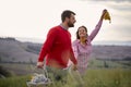 A young couple enjoying nature while walking a large meadow. Relationship, love, together, picnic Royalty Free Stock Photo