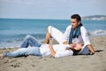 Young couple enjoying picnic on the beach Royalty Free Stock Photo