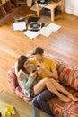 Young couple enjoying red wine on the couch Royalty Free Stock Photo