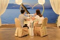 Loving couple eating romantic dinner by the beach