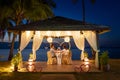 Loving couple eating romantic dinner by the tropical beach Royalty Free Stock Photo