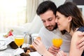 Young couple enjoying room service in suite. Royalty Free Stock Photo