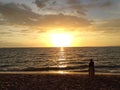 Young couple enjoying the sunset on the beach Royalty Free Stock Photo