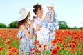 Young couple and their baby-girl in poppy field Royalty Free Stock Photo