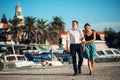 Young couple enjoying vacation time.Boyfriend and girlfriend having a romantic walk along the coast in a seaside town