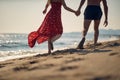 A young couple enjoying a walk on the beach. Summer, beach, sea, vacation Royalty Free Stock Photo