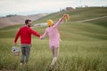 A young couple enjoying a walk on a large meadow. Love, relationship, together, nature Royalty Free Stock Photo