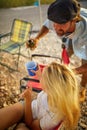 A young couple enjoys a drink at a vacation at the campsite in the nature. Relationship, love, nature, camping Royalty Free Stock Photo