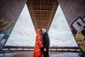 Young couple in the evening under the bridge Royalty Free Stock Photo