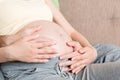 A young couple is expecting a baby. husband hugs the belly of his pregnant wife at home Royalty Free Stock Photo