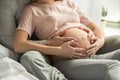 Young couple expecting baby relax on bed indoors Royalty Free Stock Photo